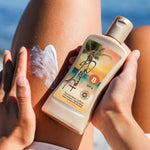 Person applying sunscreen lotion with a beach background