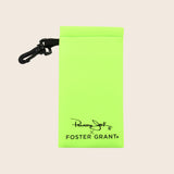 Neon green Panama Jack sunglasses pouch with black strap on a beige background
