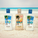 Three Panama Jack bottles of sunscreen lotion standing on a sandy beach with the ocean in the background. The left bottle is white with a blue cap and SPF 30 label, the middle bottle is beige with a gold cap and SPF 8 label, and the right bottle is white with a blue cap and SPF 50 label.