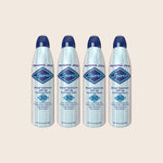 Four bottles of Panama Jack Sport sunscreen spray on a beige background