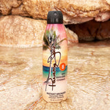 Panama Jack Sunscreen spray bottle with tropical design on a rocky background