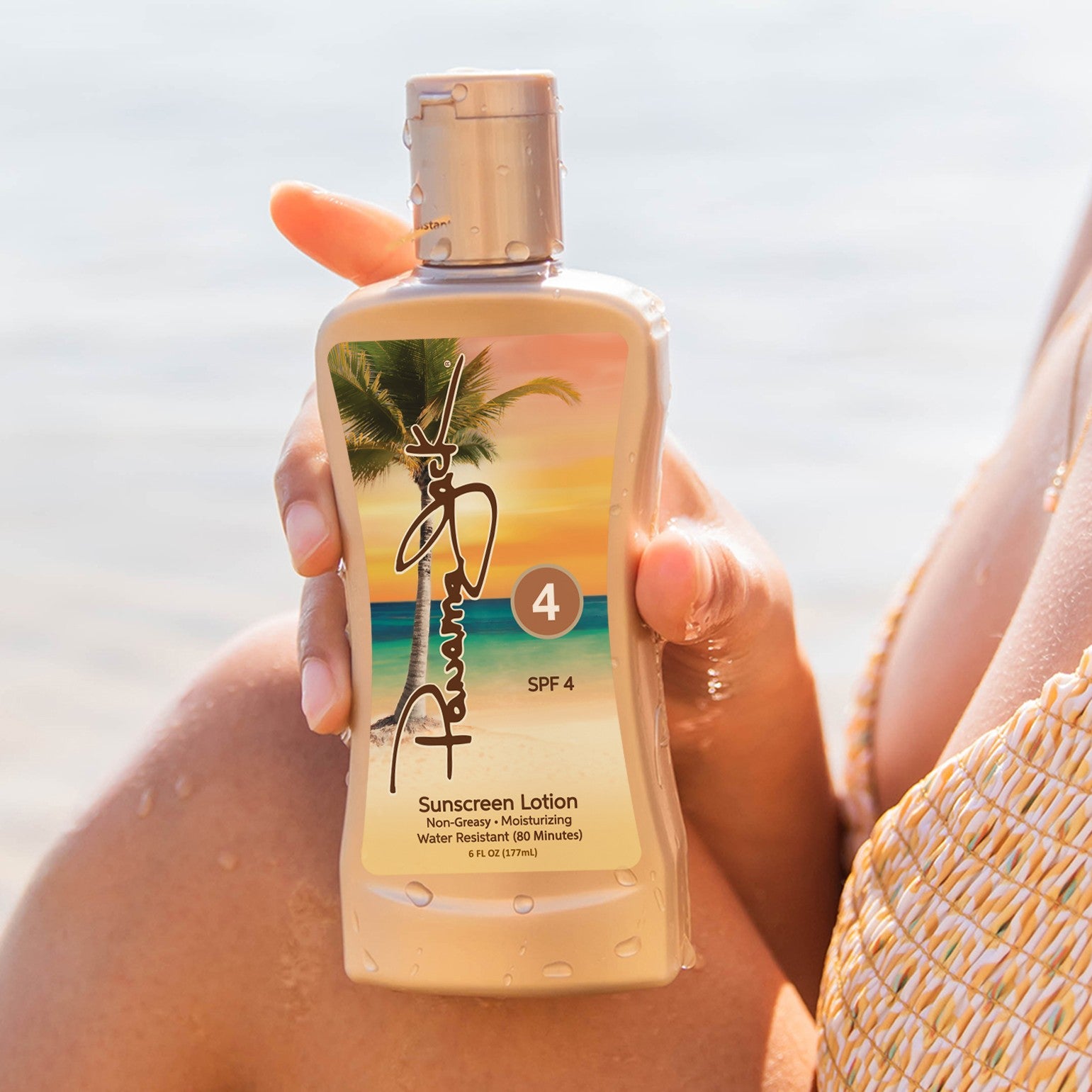 Person holding a bottle of Panama Jack  sunscreen lotion with a beach background