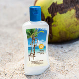 Panama Jack Sunscreen lotion bottle with SPF 15 label on sand, coconut in background