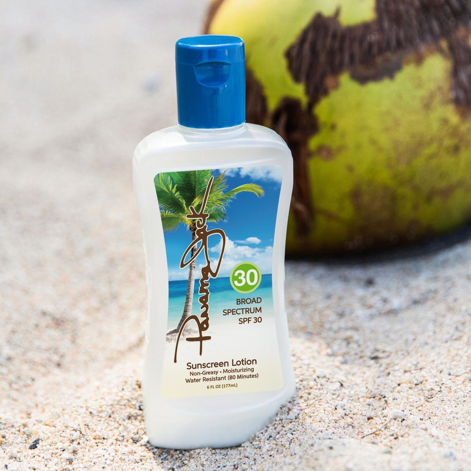 Panama Jack SPF 30 Sunscreen lotion bottle with blue cap on sand next to a coconut