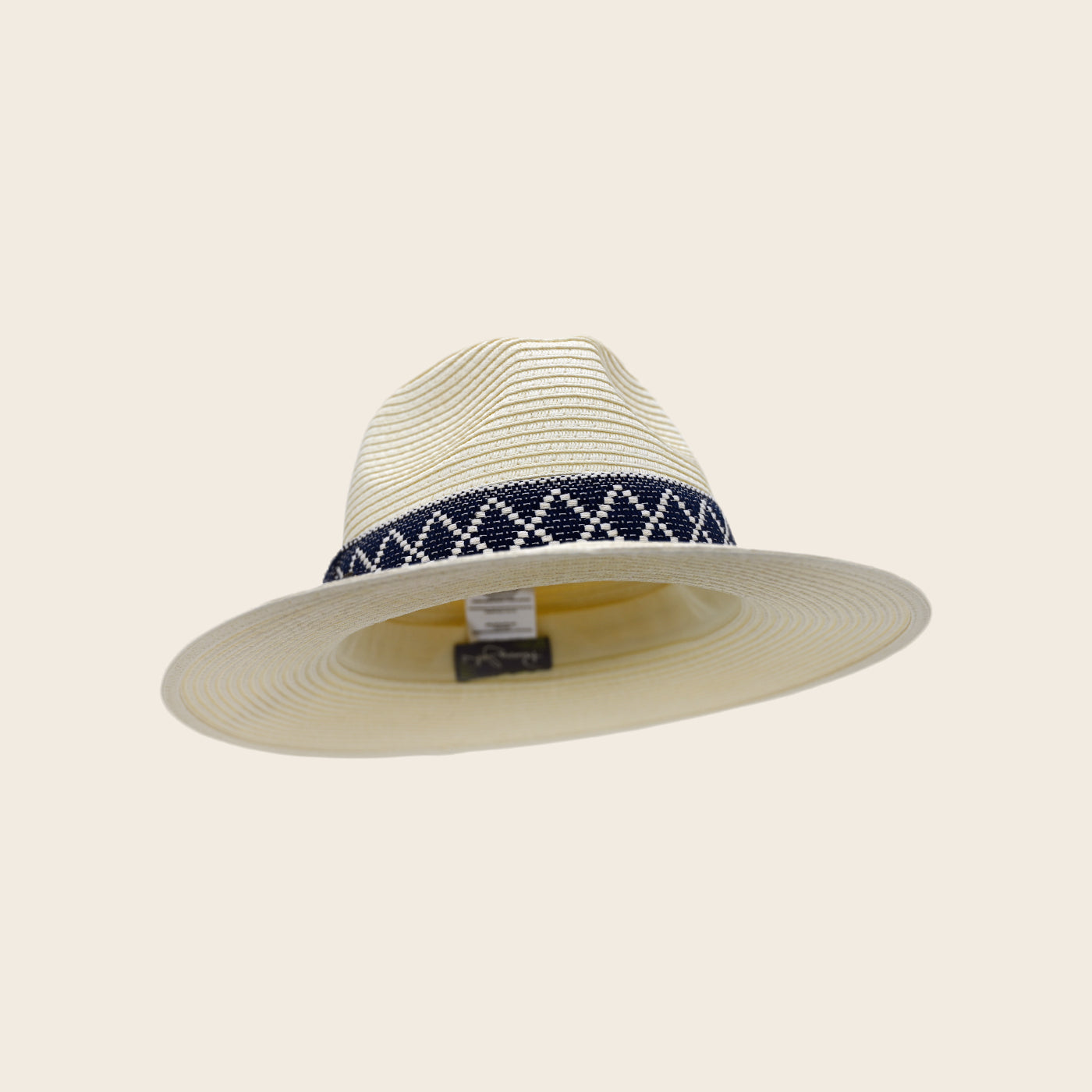 Beige Panama Jack straw hat with a navy and white patterned band on a beige background
