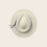 White straw Panama Jack hat with a wide brim on a light beige background
