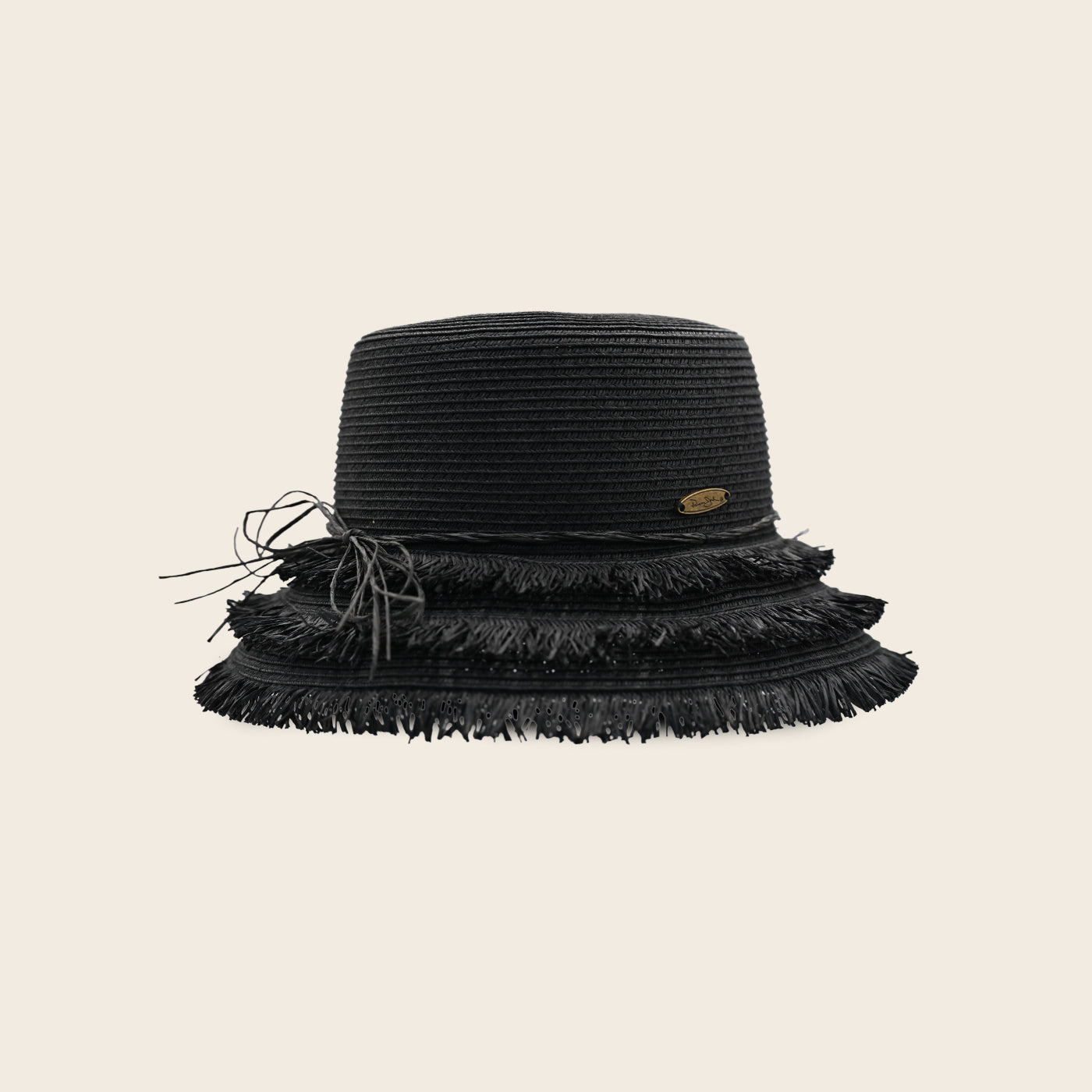 Black fringed Panama Jack hat on a beige background