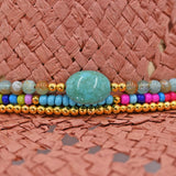 Panama Jack Colorful beaded bracelet with a turquoise stone on a woven surface