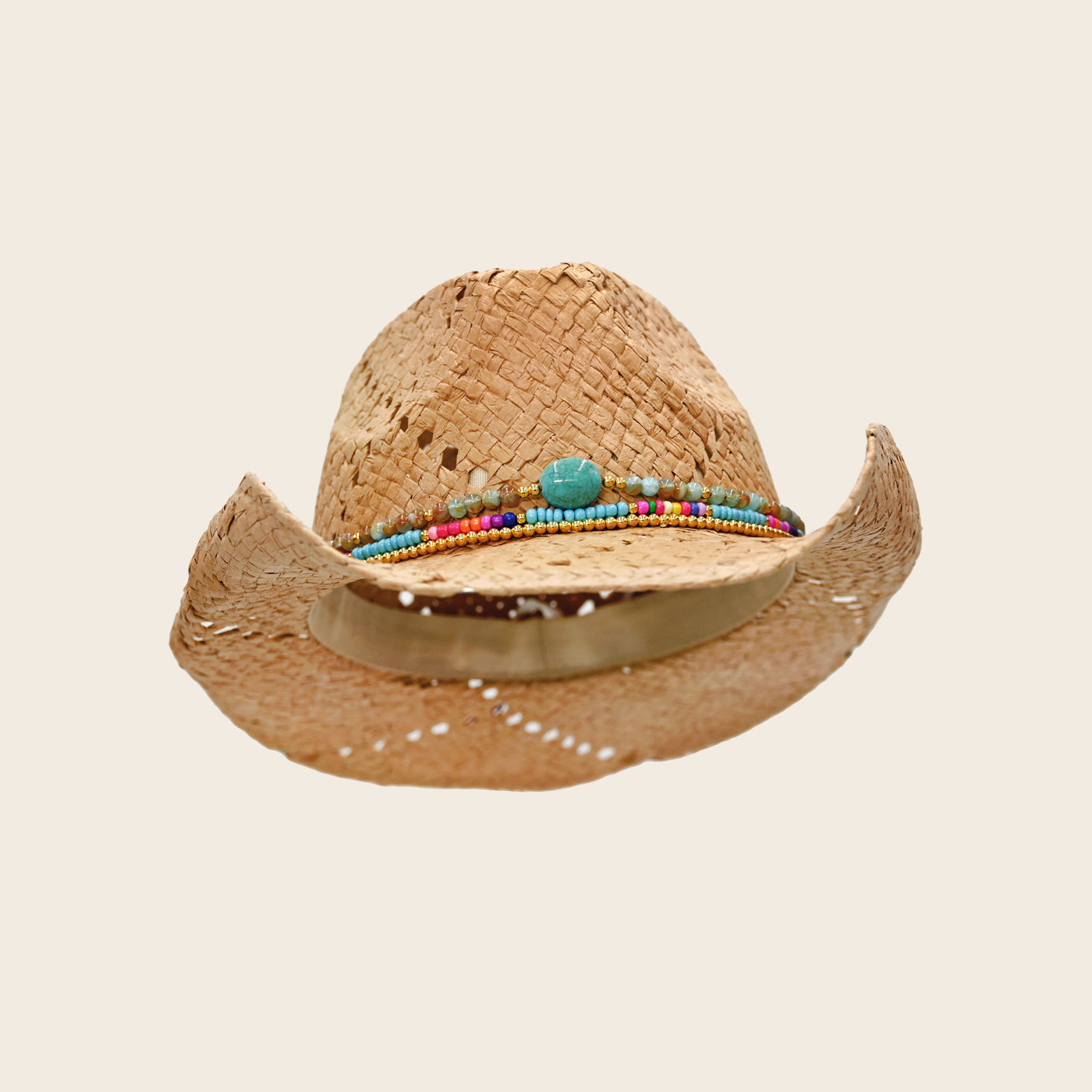 Straw cowboy Panama Jack hat with colorful bead band on a beige background
